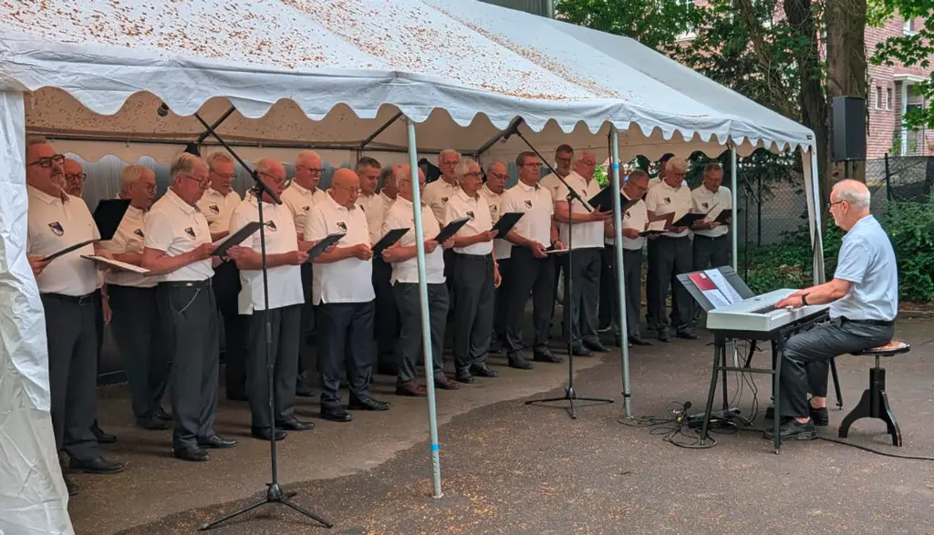 Bild vom MGV unter dem Pavillion und dem Organist davor